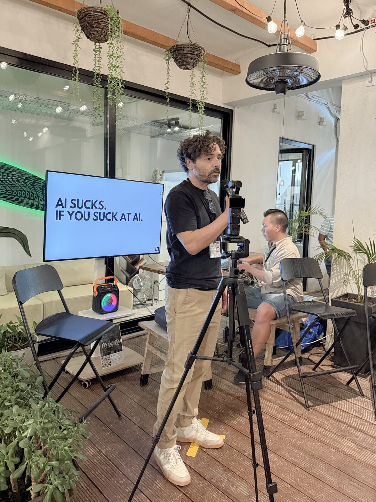 Pepe Leyton presenting in front of the AI SUCKS slide